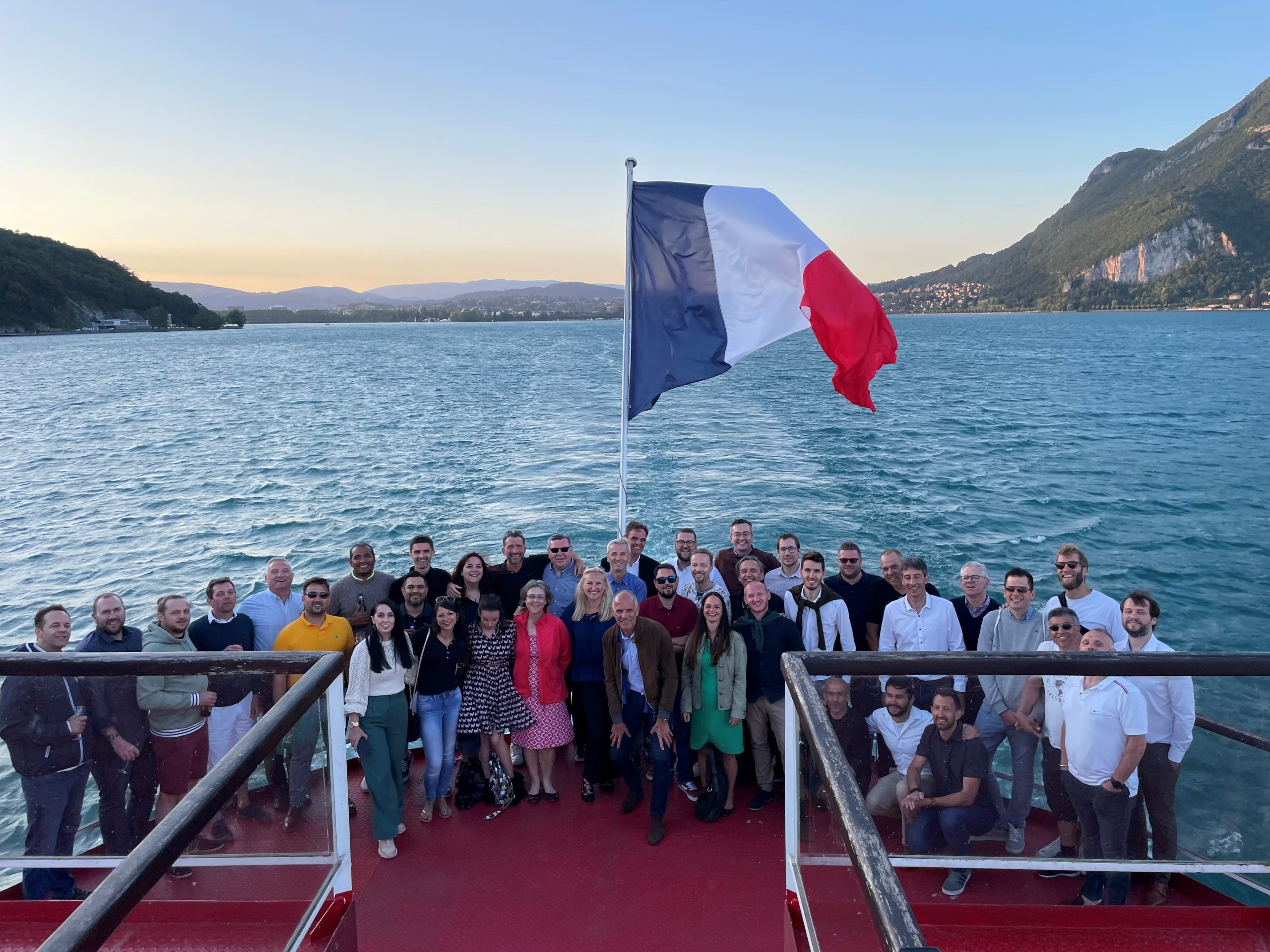 REAZN Employees with French flag and nature scenery